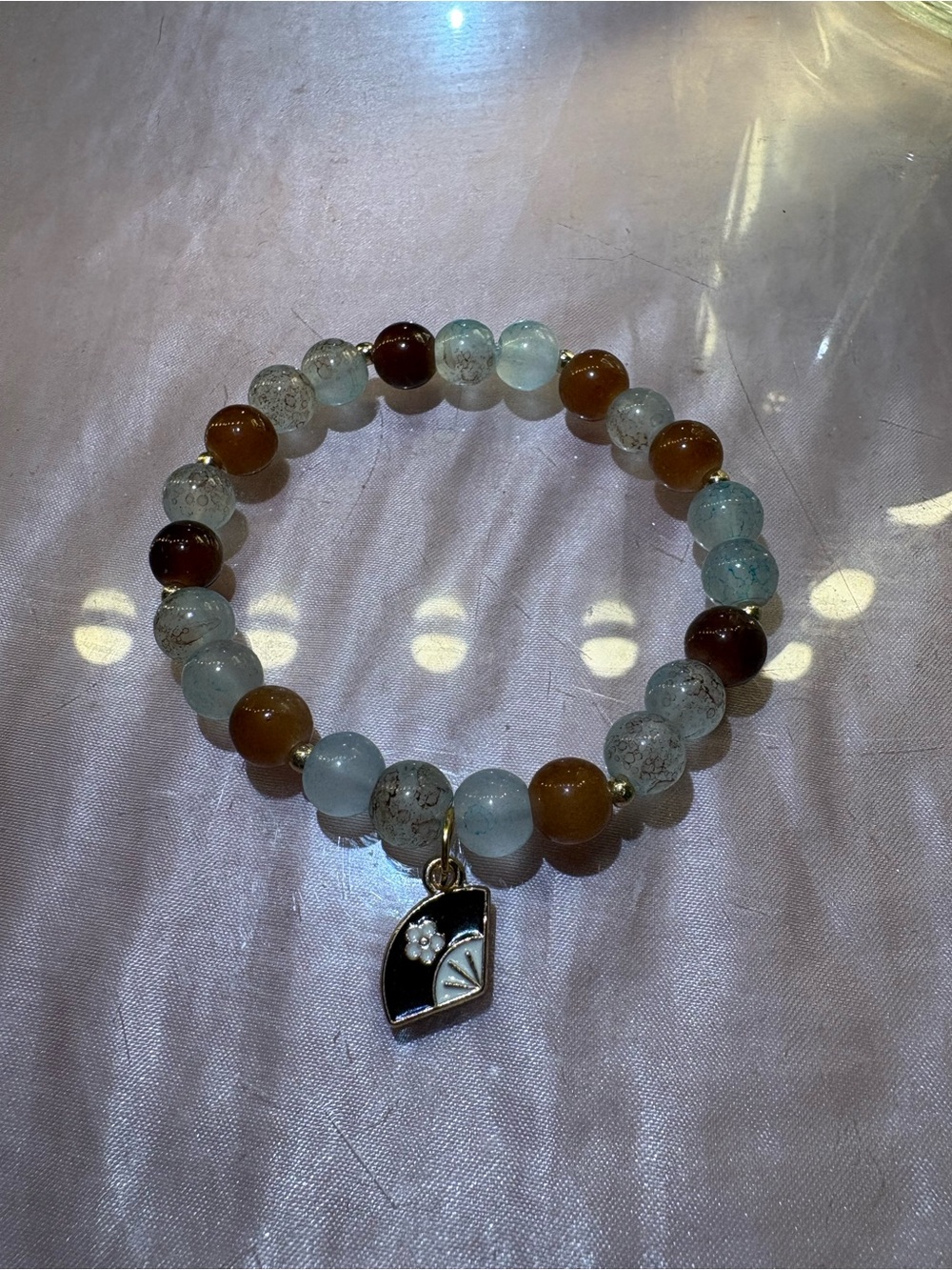 Brown, Blue and Gold beaded bracelet with brown hand fan charm
